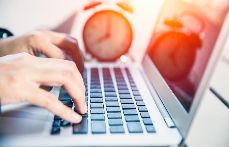 Lawyer on keyboard watching clock manage time