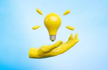 hand presenting a light bulb, good ideas for rewarding referral sources