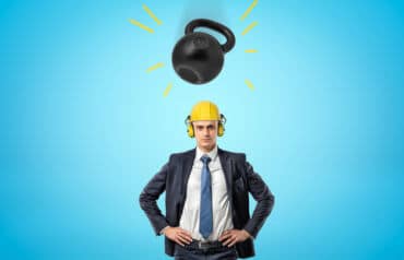 lawyer handling change standing under a kettle bell