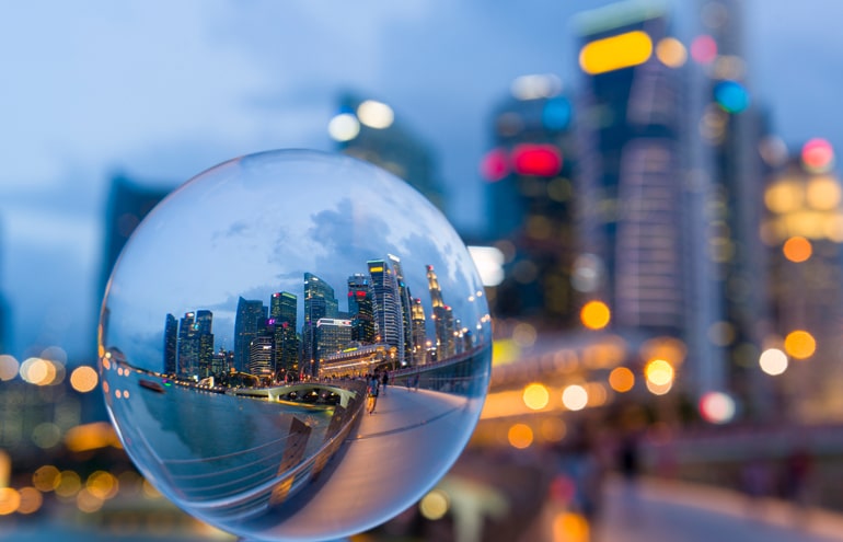 crystal ball with office buildings in-person meetings