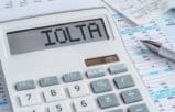 Calculator displaying IOLTA on top of financial documents for law firm IOLTA accounting