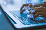 lawyer typing on a keyboard with icons representing social media for law firms