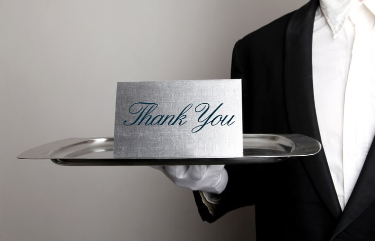 thank you notecard presented on an elegant silver tray