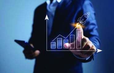 A professional points to a rising bar graph with a rocket launch icon, symbolizing Mission-Driven Law Firm Growth and performance.