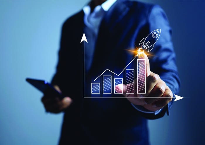 A professional points to a rising bar graph with a rocket launch icon, symbolizing Mission-Driven Law Firm Growth and performance.