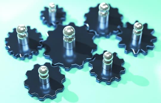 Abstract illustration of several interlocking dark metal gears with polished silver axles, symbolizing collaboration, internal firm structure, and Practice Group Leader effectiveness.