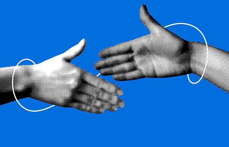 Two hands reaching for a handshake to symbolize trust in law firm lateral partners.