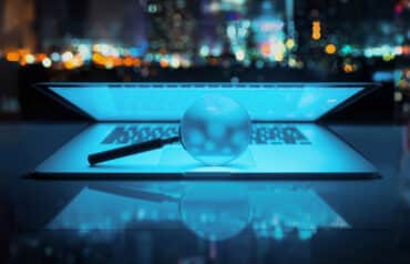 Magnifying glass over a glowing laptop, symbolizing the analysis of AI metrics for law firms.