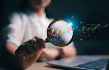 Analyzing financial charts, representing the complexity of selling a small law firm.