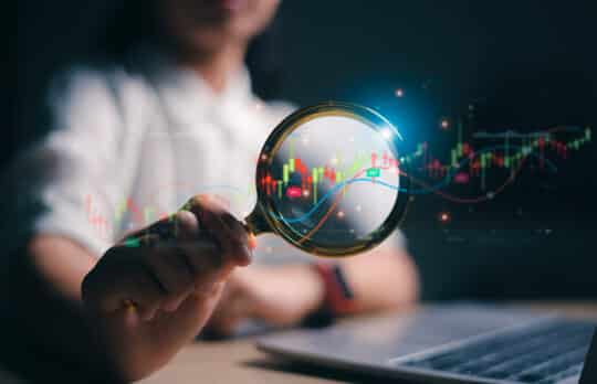 Analyzing financial charts, representing the complexity of selling a small law firm.