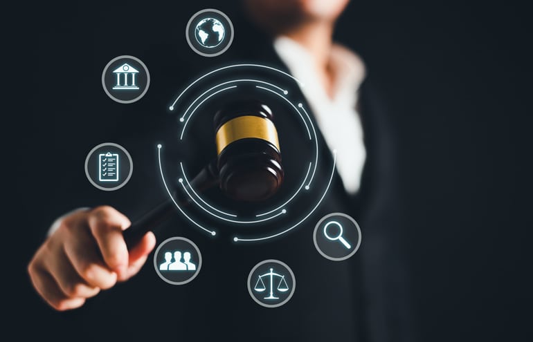 An attorney holding a gavel circled by glowing digital application icons, representing a lawyer apps ecosystem.