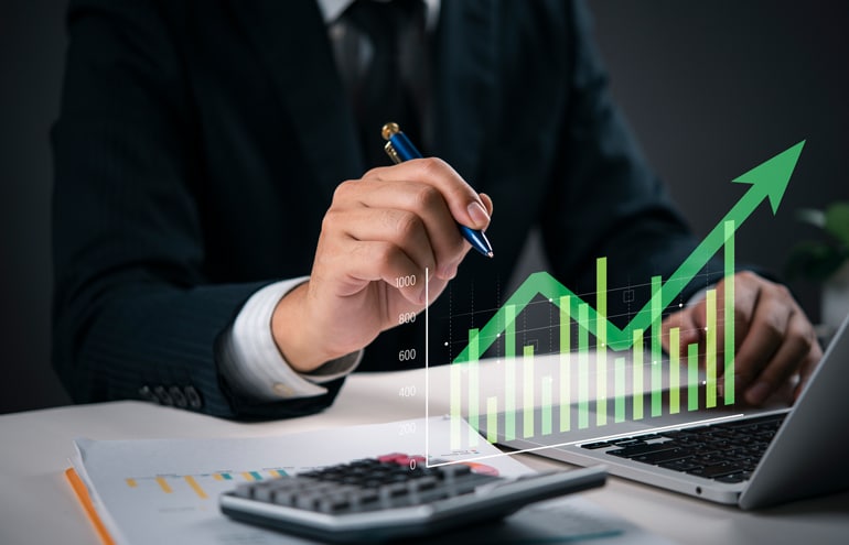Law Firm Growht: law firm partner working on a laptop computer with charts