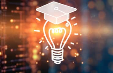 light bulb with a college graduation cap representing AI training for lawyers