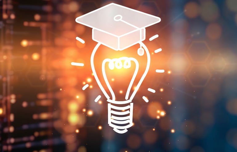 light bulb with a college graduation cap representing AI training for lawyers