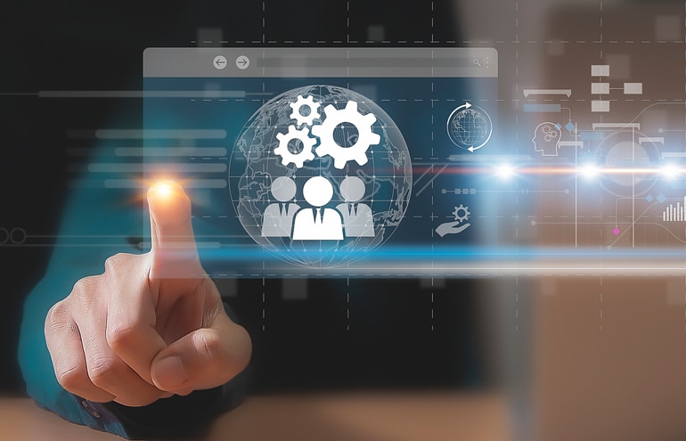 A person's hand pointing at a digital interface showing abstract team icons and gear systems over a globe, illustrating the integration of technology and systems management in law firm HR.