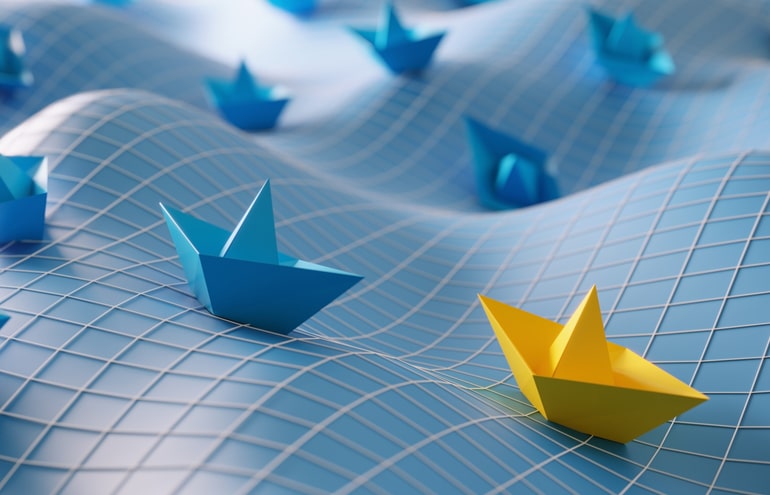 A yellow paper boat leading blue boats across a wavy grid surface, illustrating executive law firm leadership.