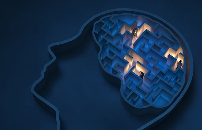 Tiny people navigating a complex brain maze with flashlights, illustrating emotional intelligence and lawyer people skills.
