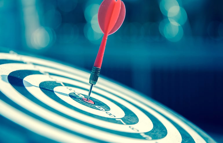A red dart hits the center of a blue bullseye target, symbolizing precision media placement for lawyer public relations.