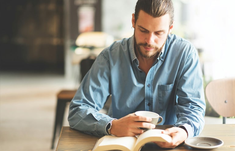 young lawyer reading a book contemplating opening a law practice