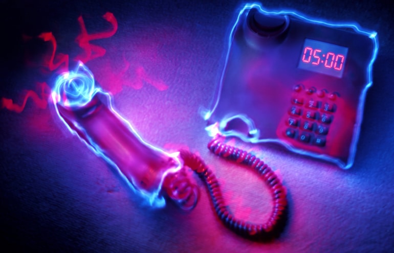 A glowing blue telephone receiver off the hook next to a five-minute timer, representing a legal intake call.