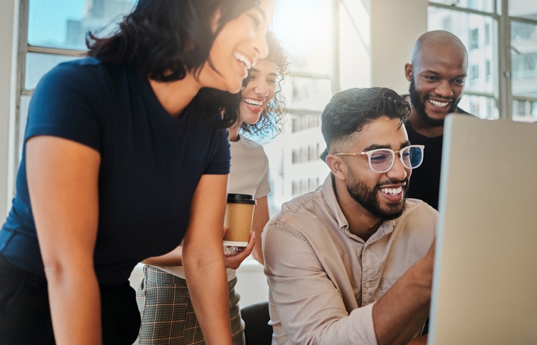 Diverse law firm staff collaborating on a computer screen representing legal staffing strategies