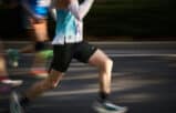Two men running side-by-side outdoors, illustrating how physical endurance and marathon training improve trial attorney skills.